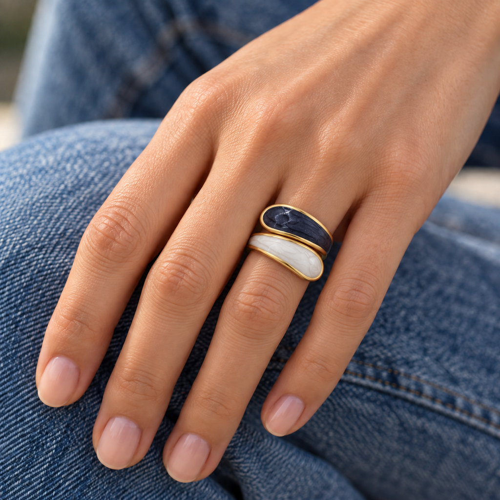 Alba Ring virtual try-on with curved dark and ivory enamel ends fitted closely around one finger