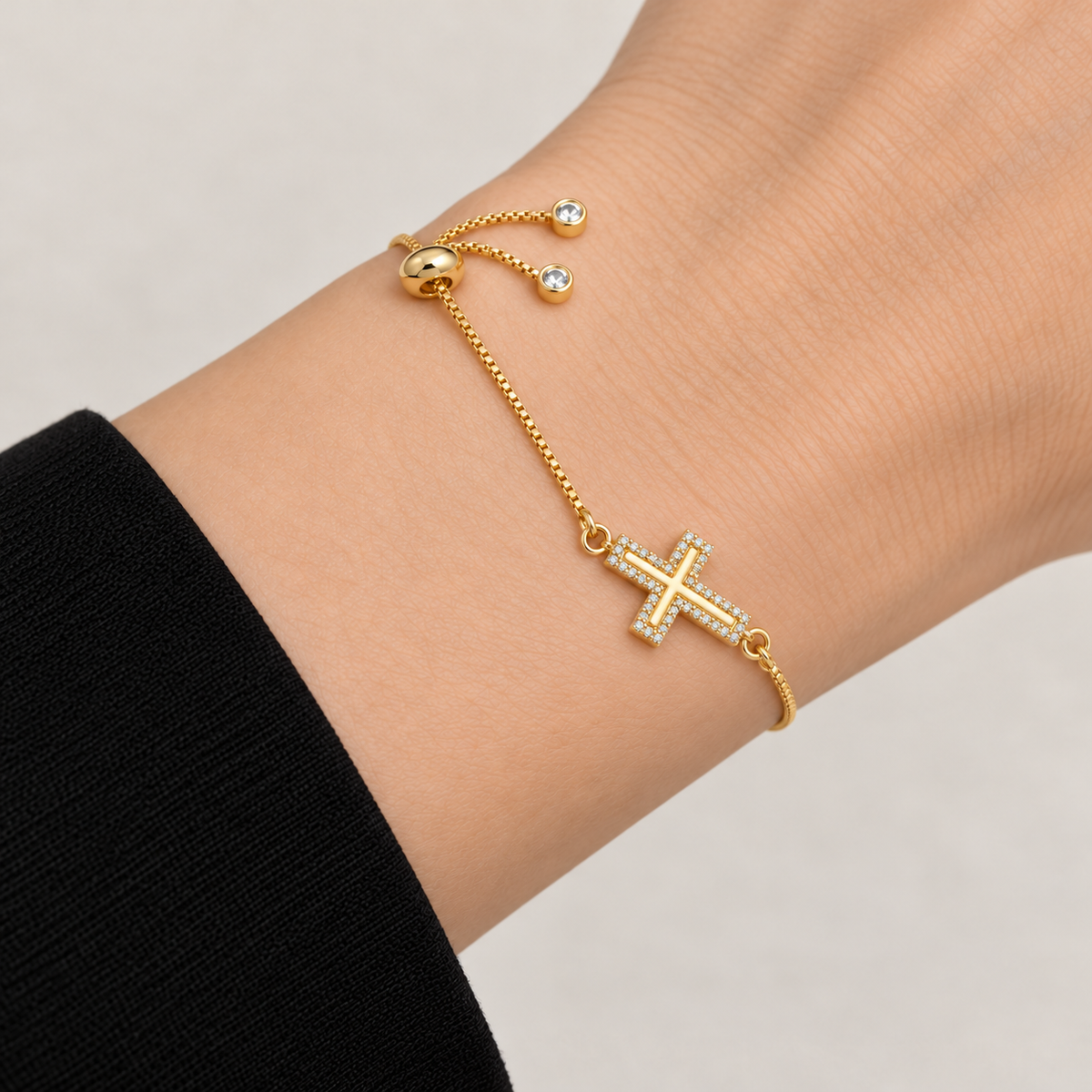 Cross Shine Adjustable Bracelet worn on wrist, with a single crystal-bordered cross and adjustable slider closure
