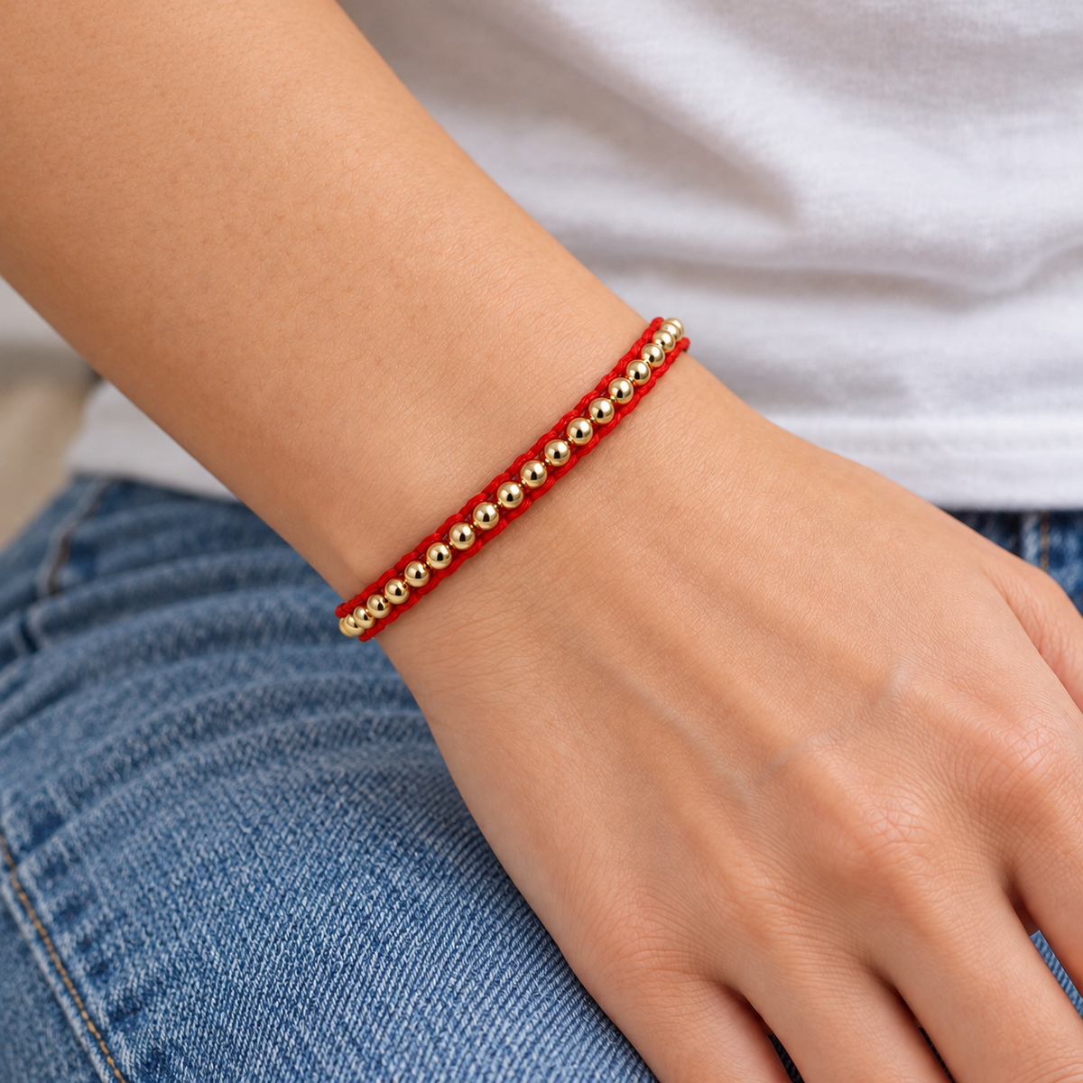 Gold Filled Red Cord Bracelet worn with casual everyday clothing