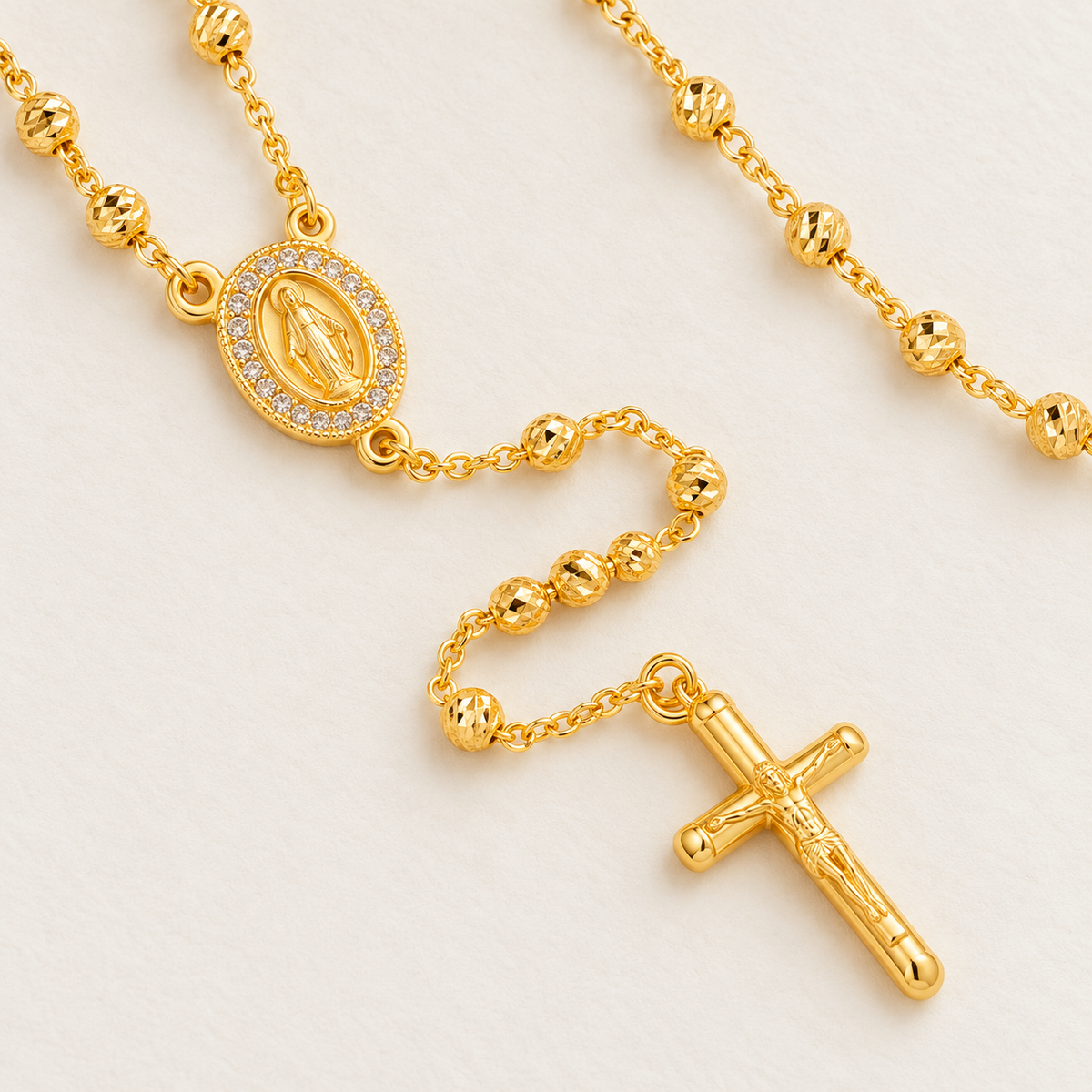 Lucia Petite Gold-Plated Rosary close-up – textured gold beads, medallion and crucifix