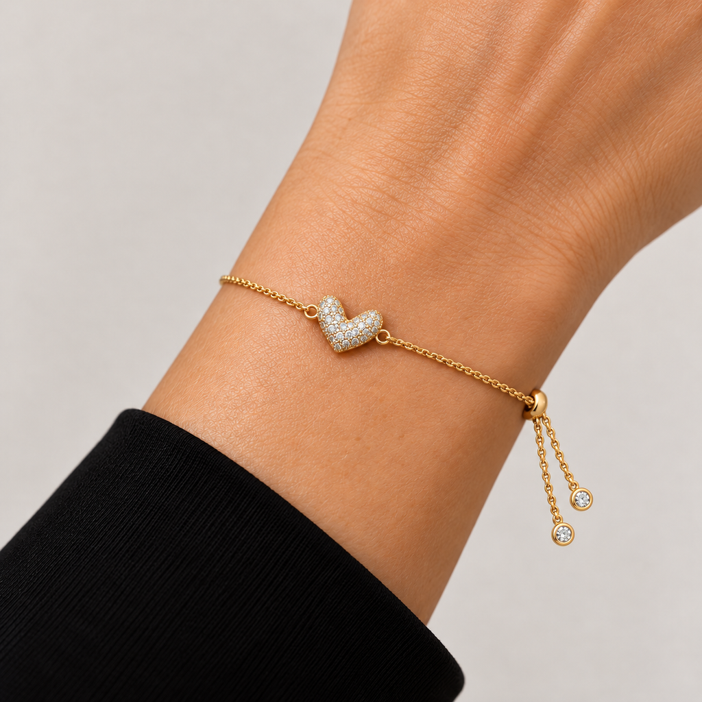 Pavé Infinity Heart Adjustable Bracelet worn on wrist, showing sliding clasp and two crystal-tipped chain ends