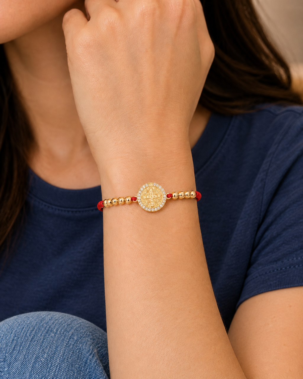 Red Saint Benedict Cord Bracelet worn with casual everyday clothing